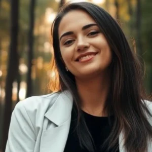 A woman with long hair and a jacket on.