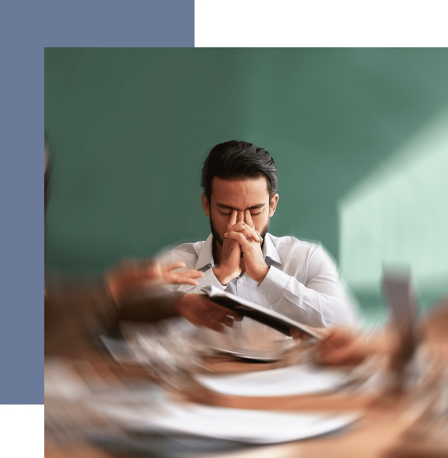 A man sitting at a table with papers in front of him.