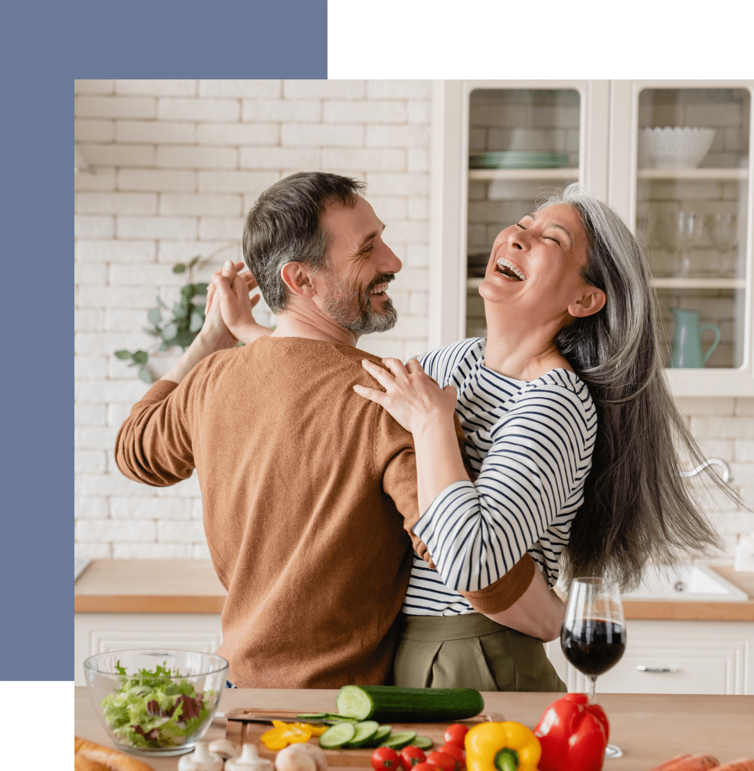 A man and woman are dancing in the kitchen.